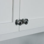 White cupboard with black color knobs